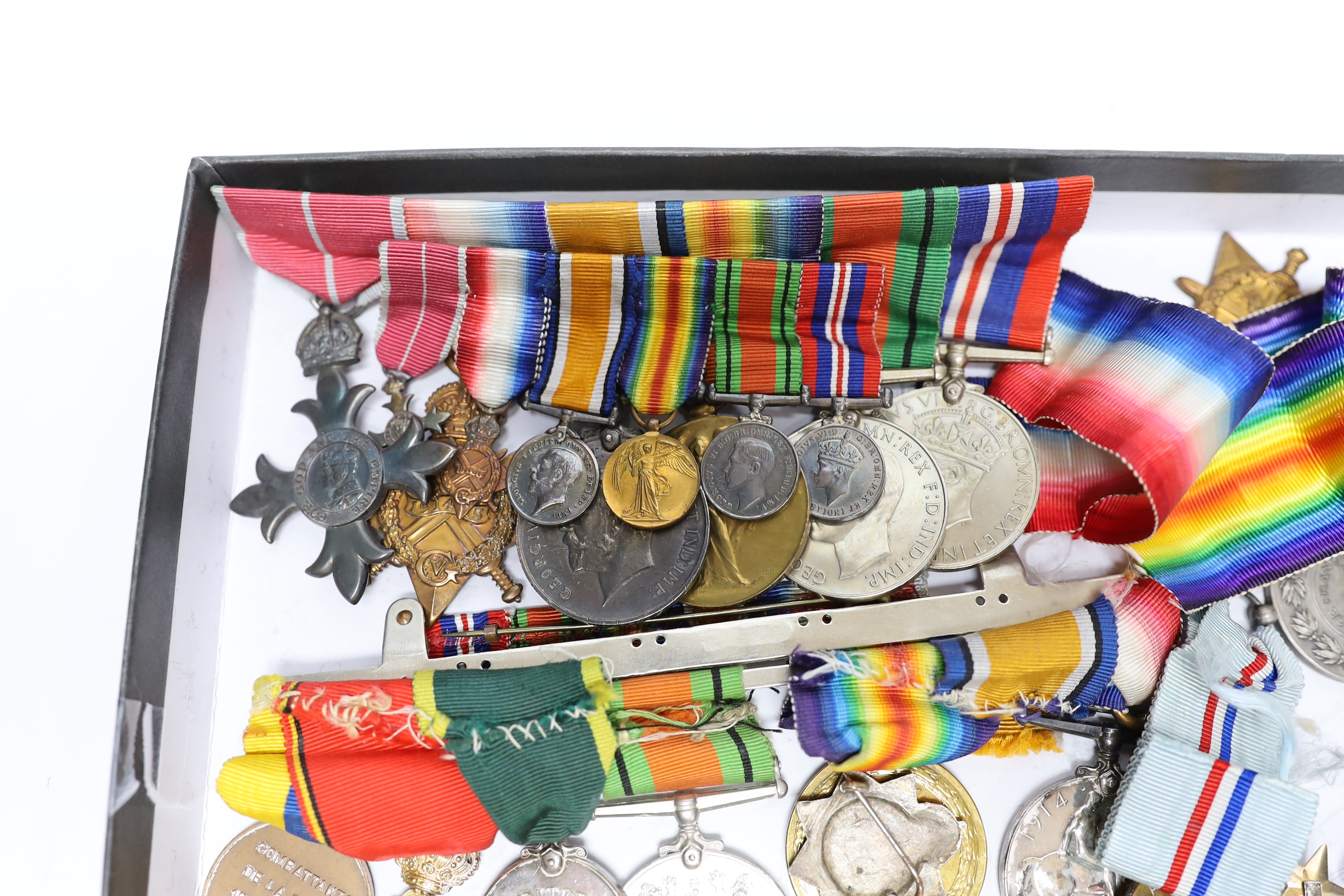 A collection of eighteen medals and some associated miniatures; a WWI/WWII group including a military MBE, WWI trio, WWII Defence and War medals to J.I.B. Farrant R.N. together with its miniature group and bar